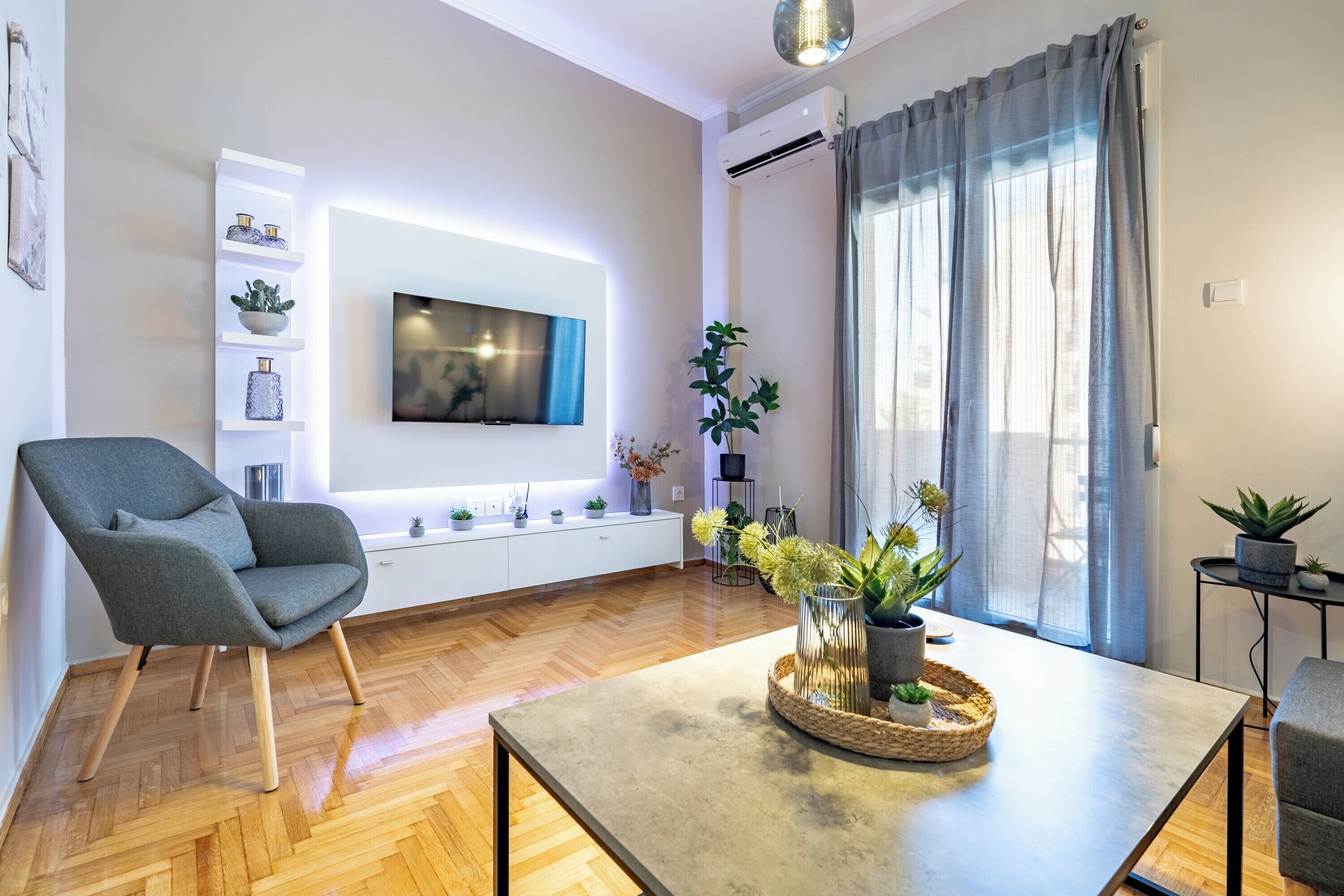 Modern living area with parquet floors and TV